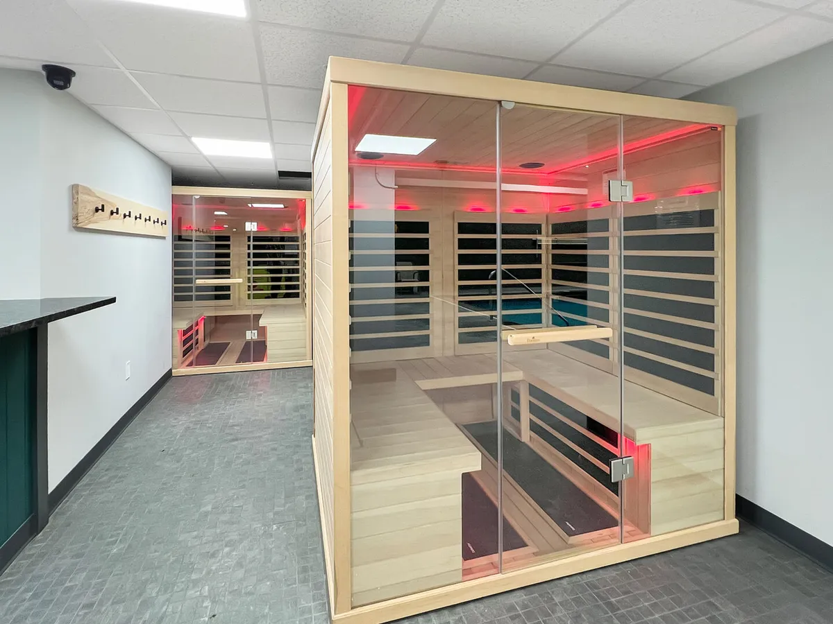 A tranquil sauna room with soft lighting and wooden benches, creating a serene environment for relaxation and après-ski recovery. The space looks warm and inviting, ideal for unwinding after a day on the slopes.